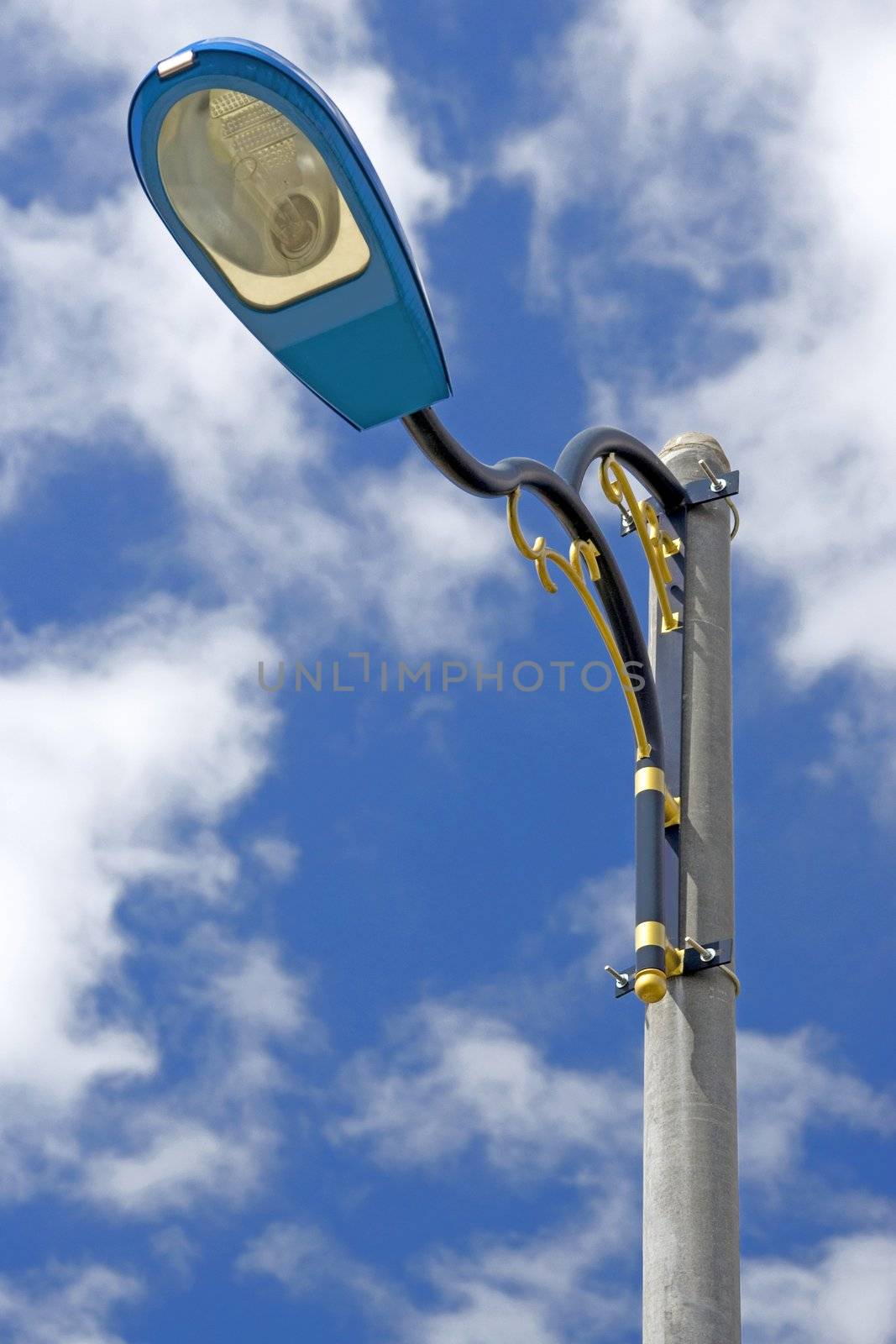 Image of a lamp post against a blue sky background.