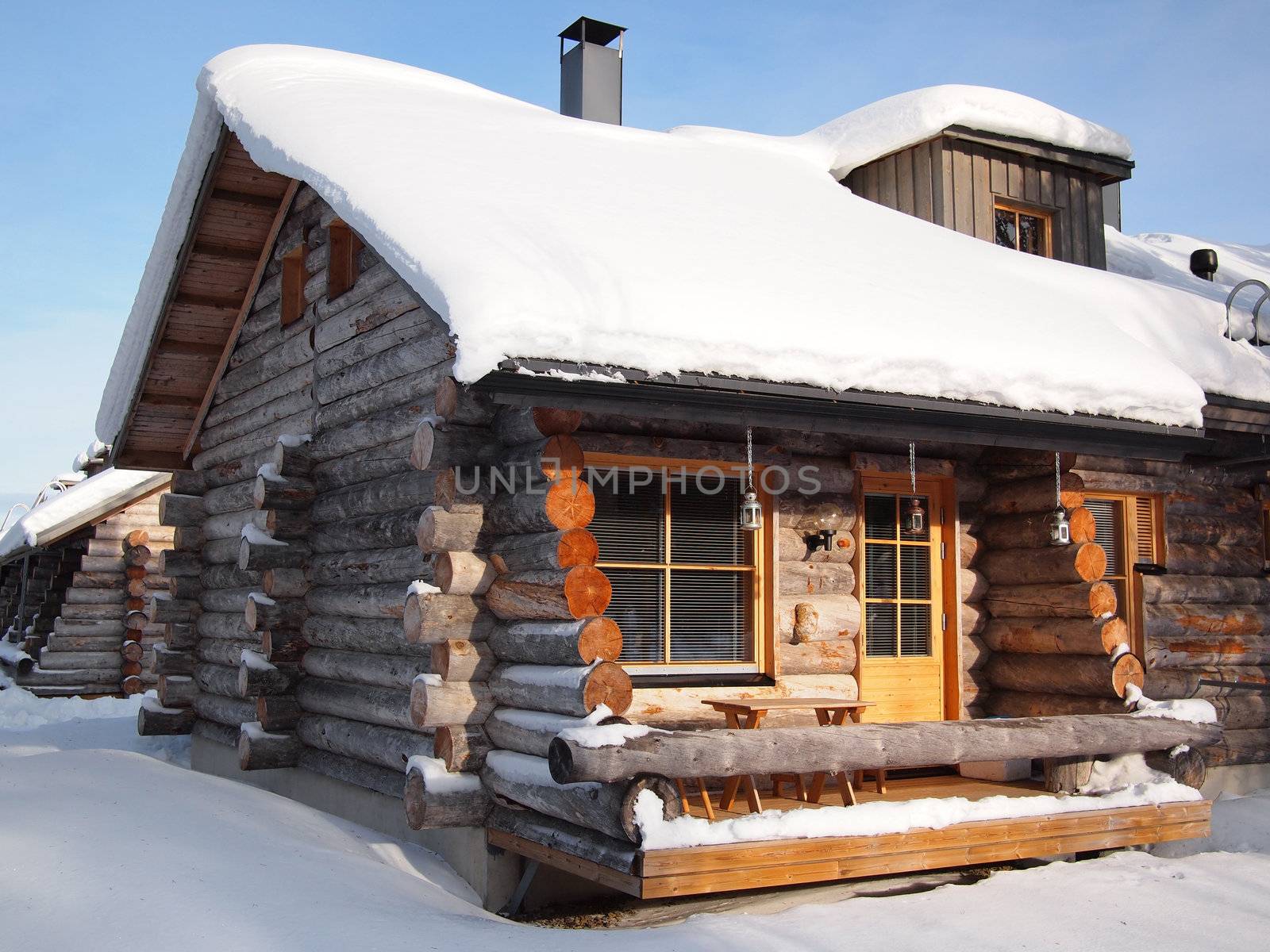 Traditional snow covered log cabin by pljvv
