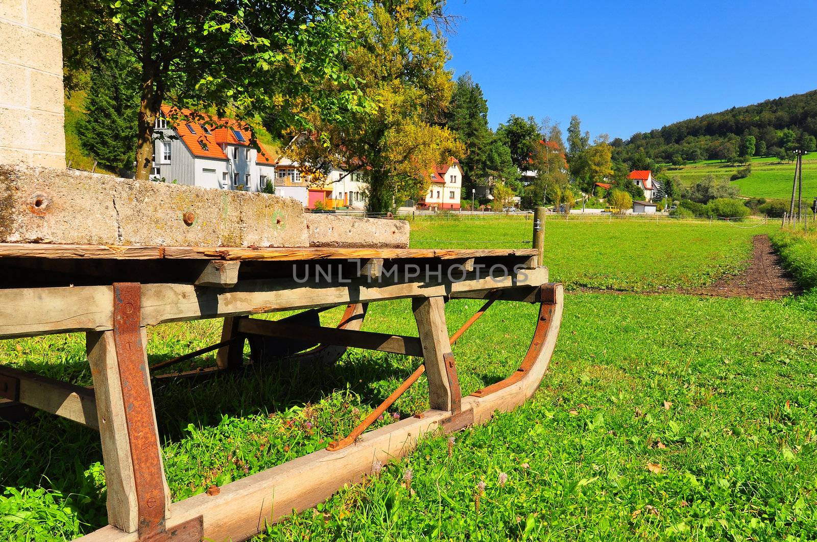 An old sleigh with the typical landscape of the Swabian Alb in the background, Baden-Wuerttemberg, Germany