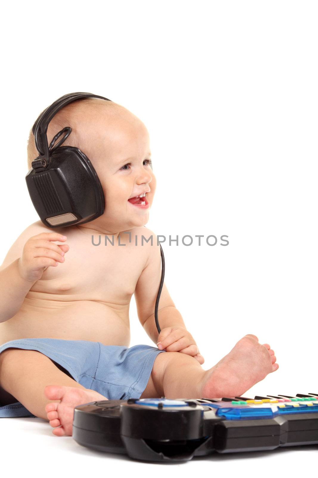 Little boy in headphones on the white background
