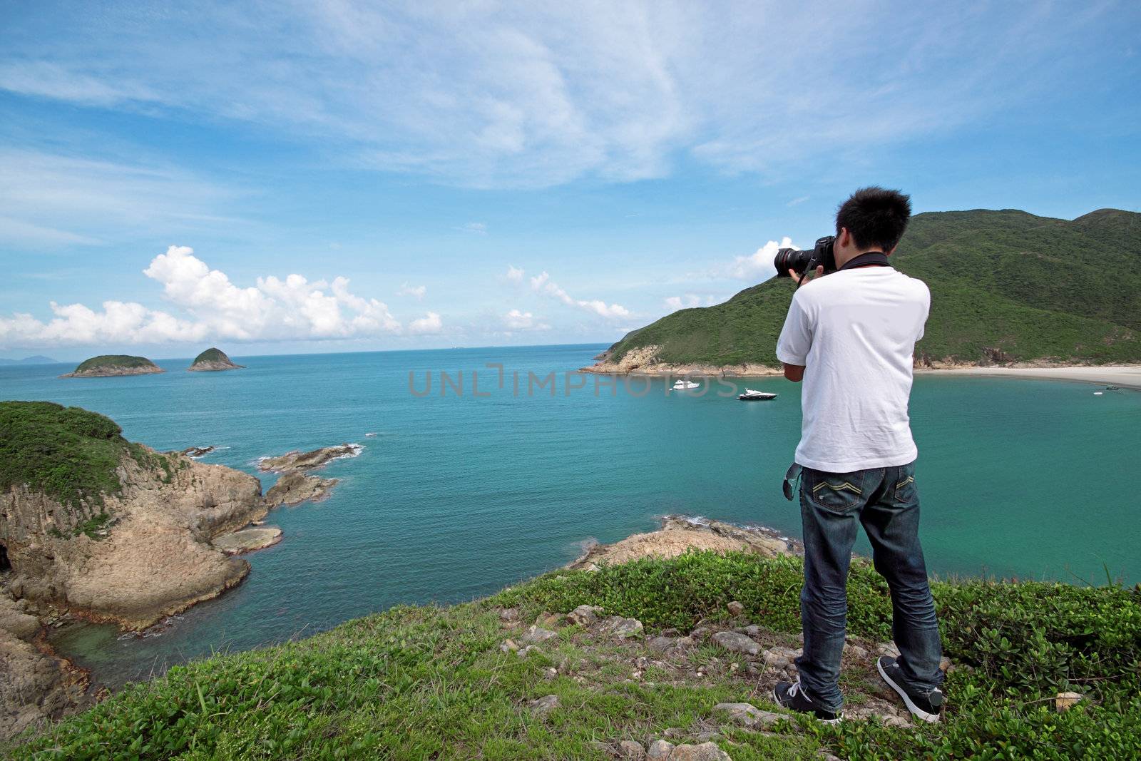 photographer takes a photo of the landscape  by cozyta