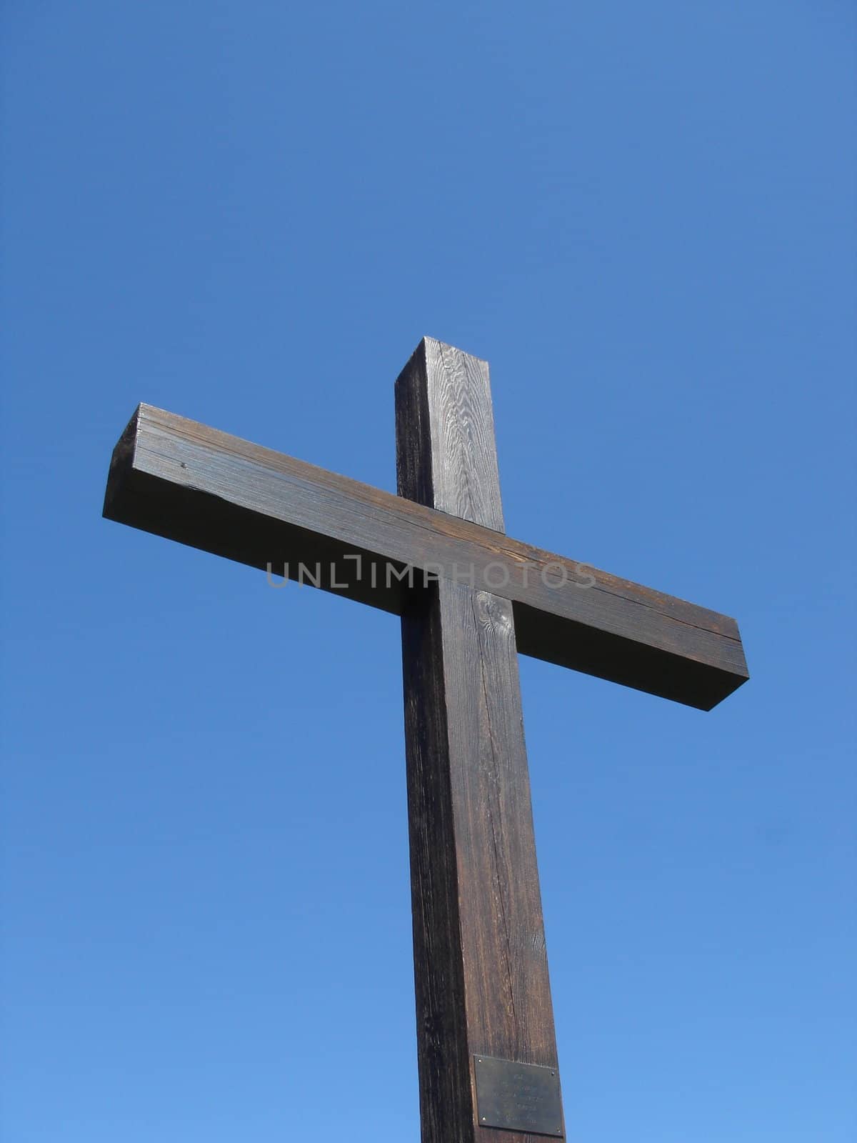 Brown wood cross and deep blue sky