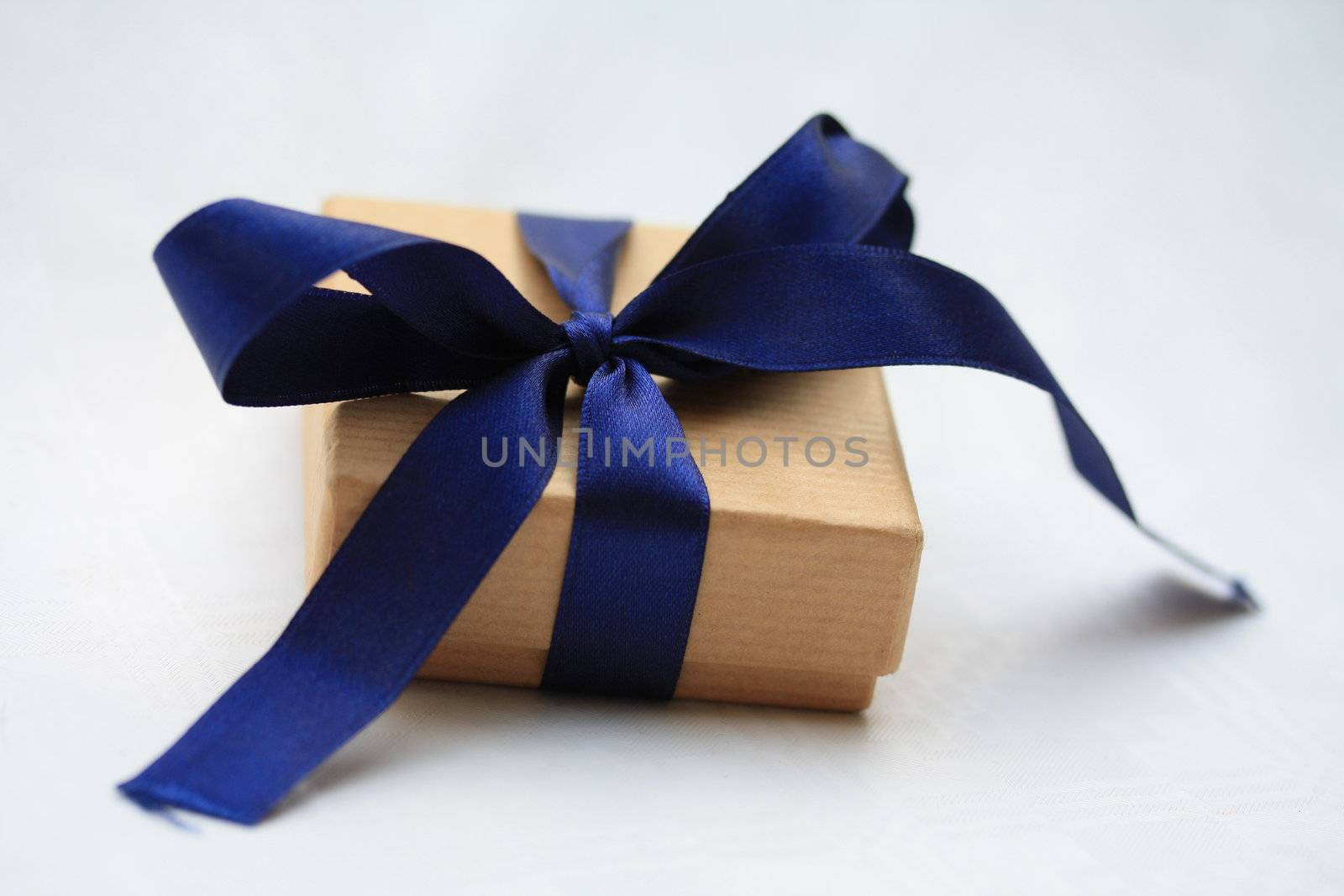 giftbox with blue ribbon by studioportosabbia