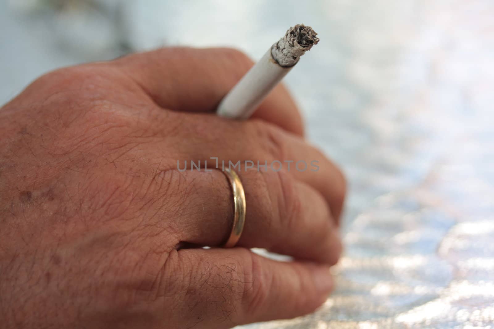 Man holding cigarette by studioportosabbia