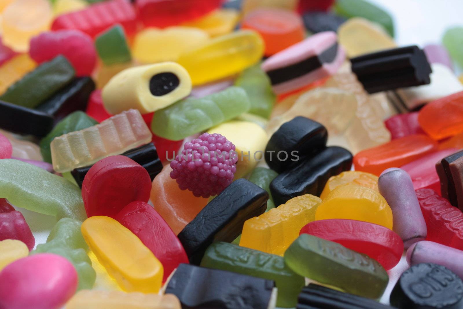 pile of assorted candy: liquorice allsorts, wine gums