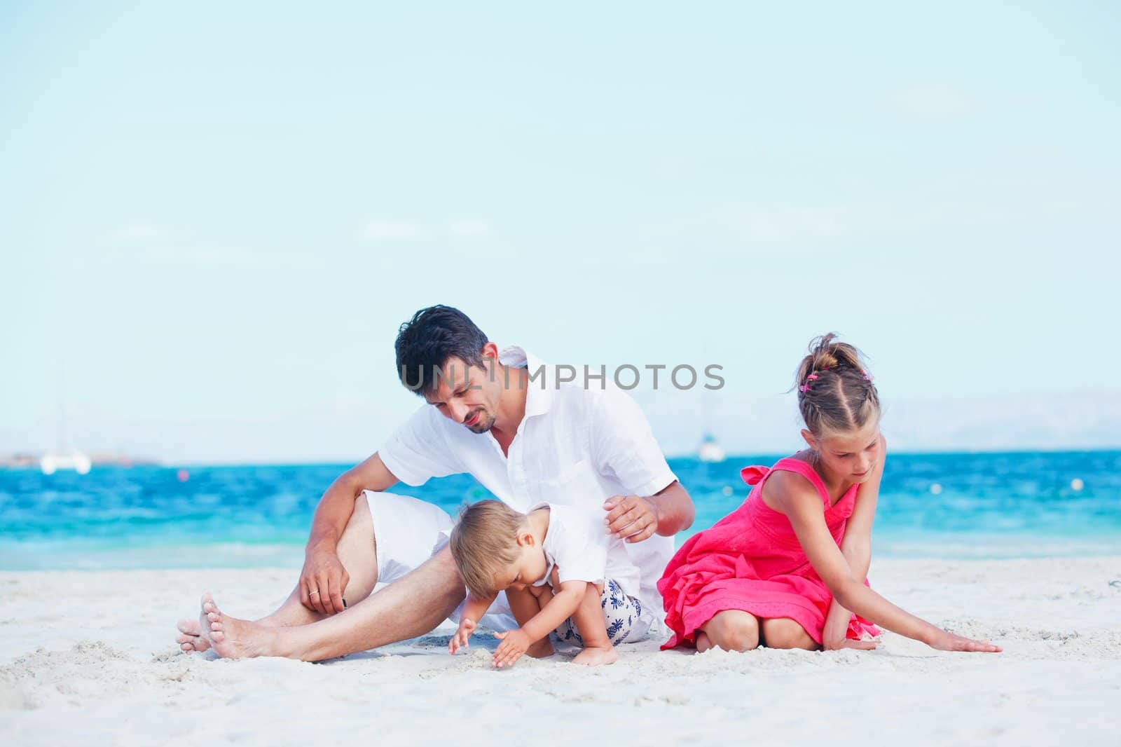 Portrait of happy young family by maxoliki