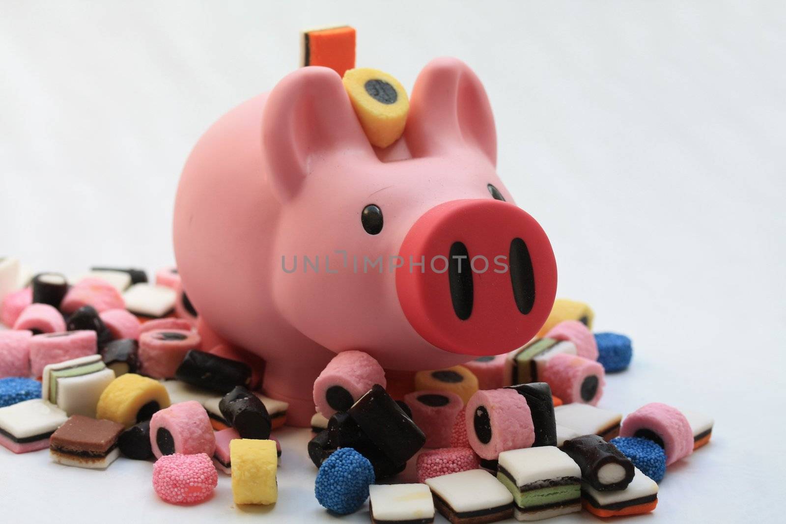 Fat pink pig on a pile of candy