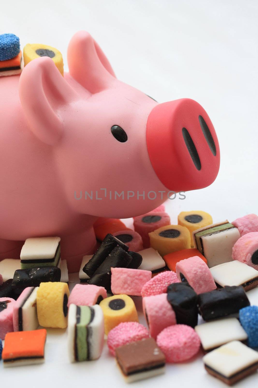 Fat pink pig on a pile of candy