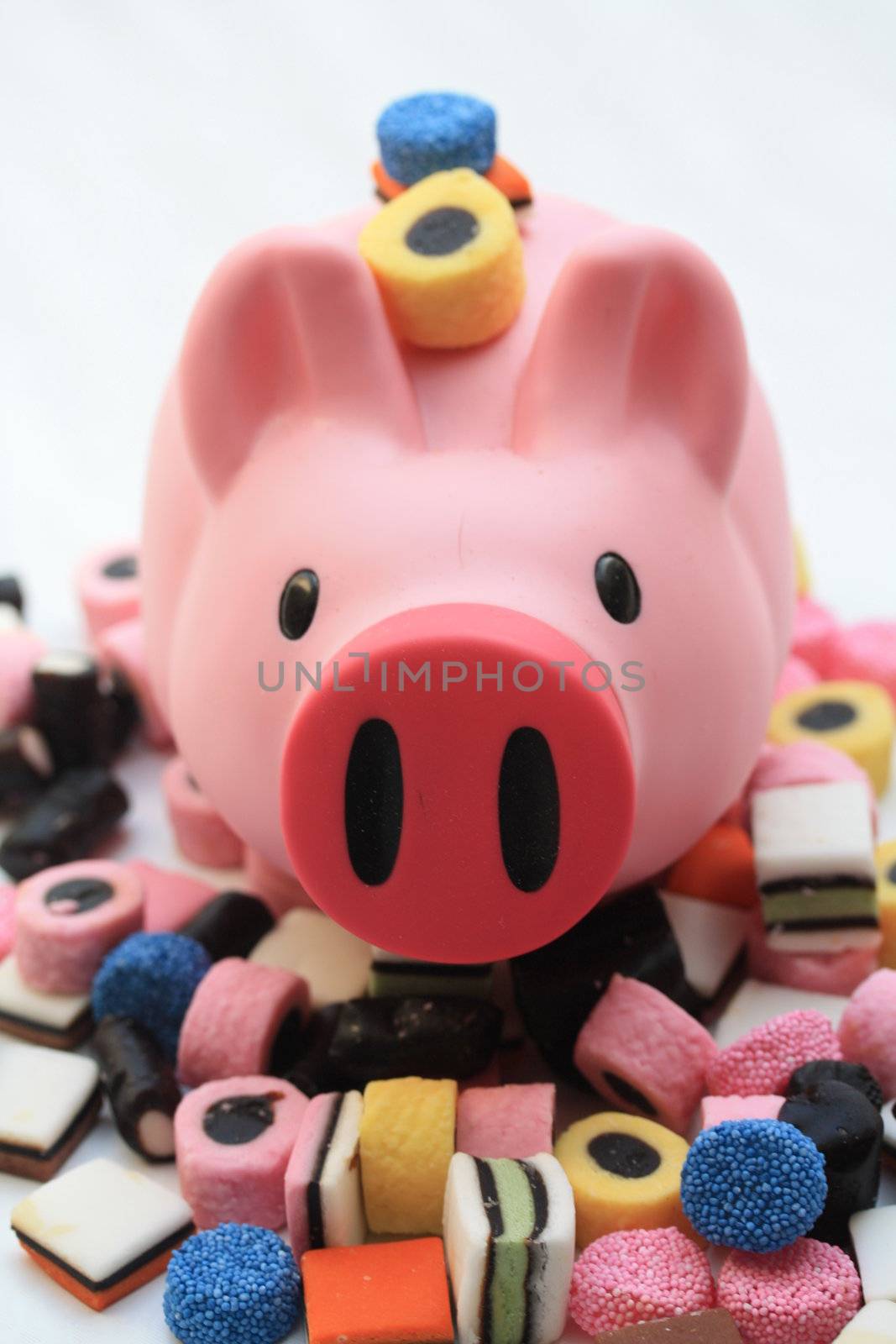 Fat pink pig on a pile of candy
