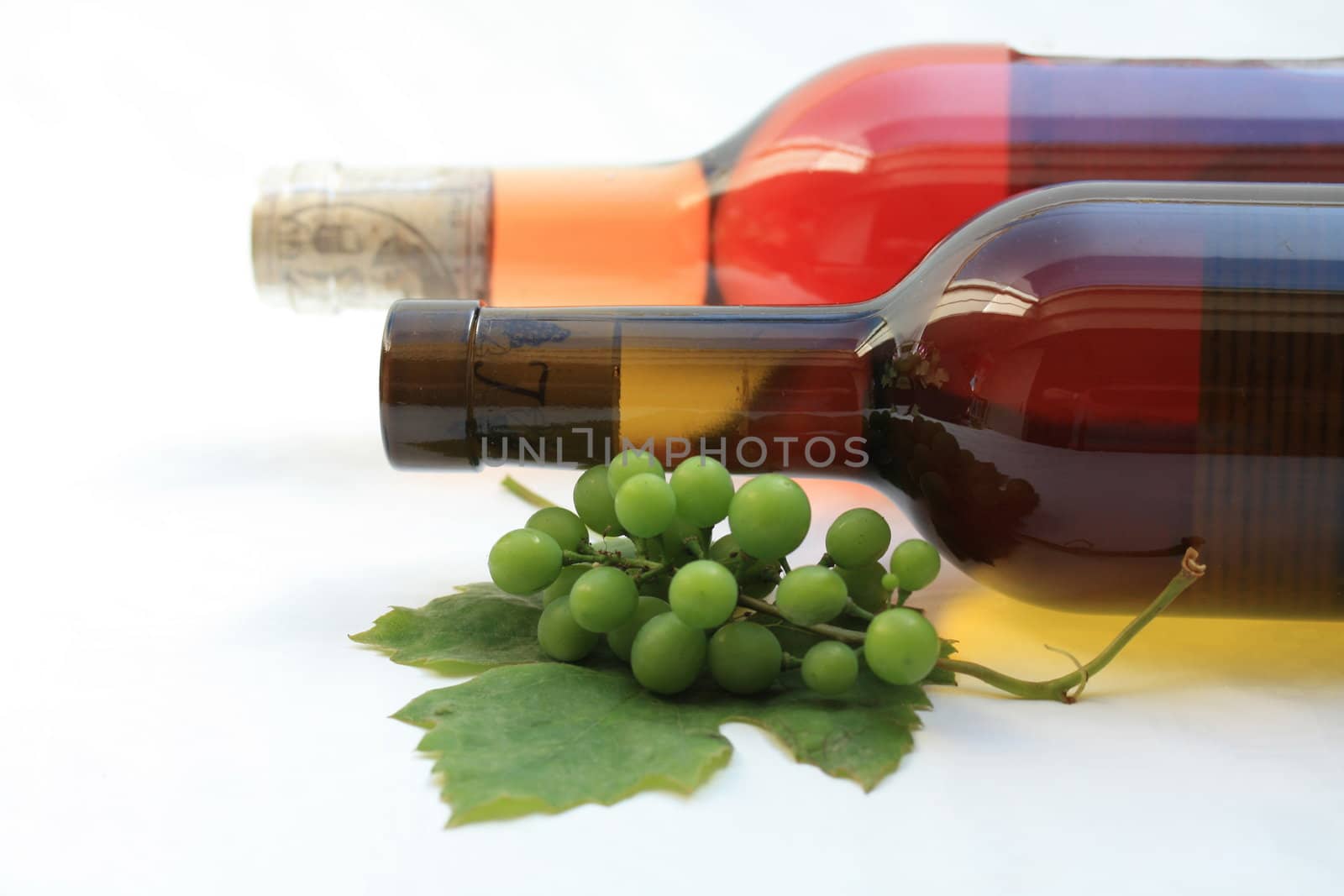 Bottle and grape leaves