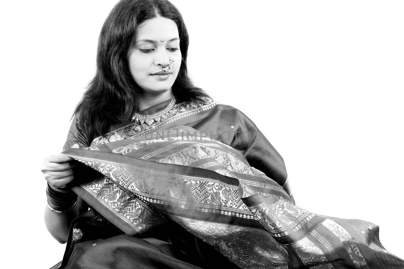 A classic portrait of a beautiful Indian woman in a sari, on white studio background.