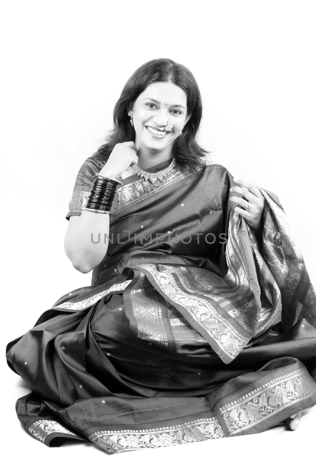 A classic black & white image of a traditional Indian woman on a white background.