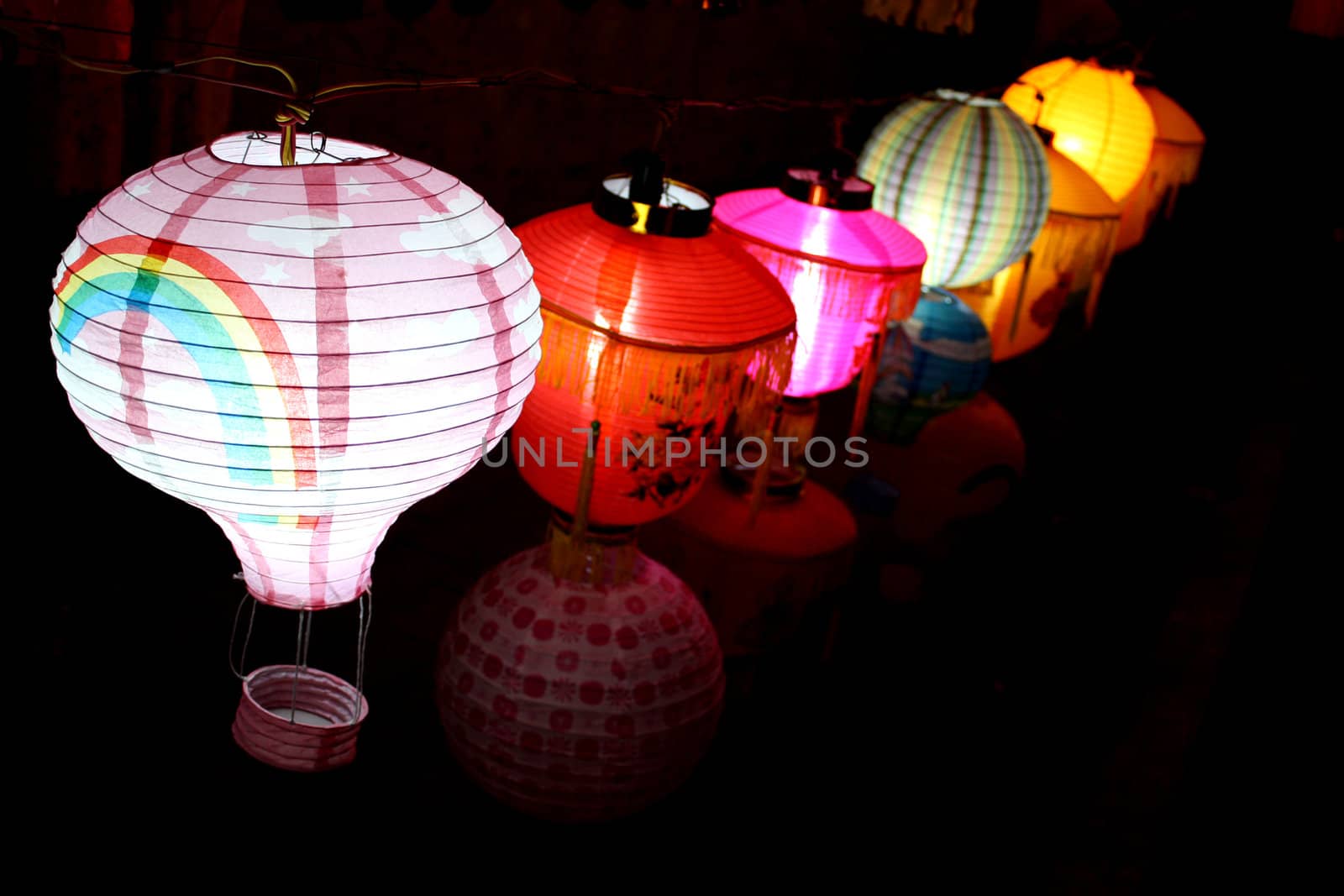 A line of beautiful colorful sky-lanters lit up on the occasion of a festival in India.