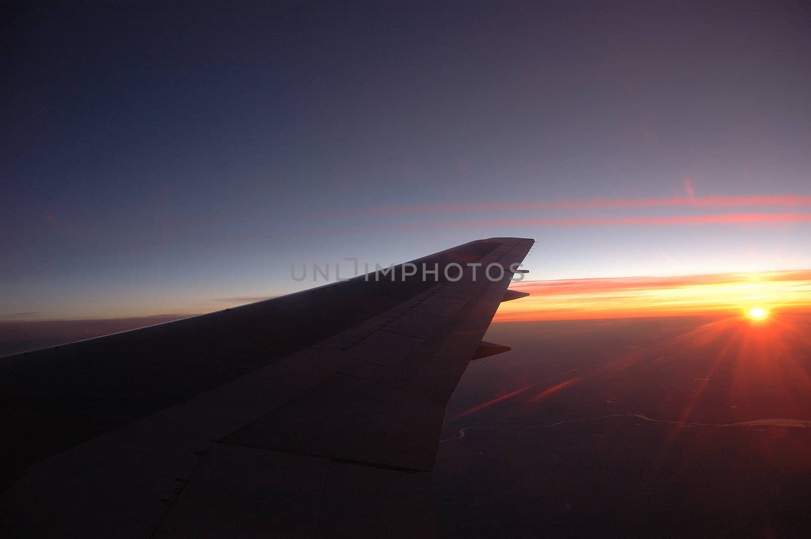 aircraft wing with blue sky as background