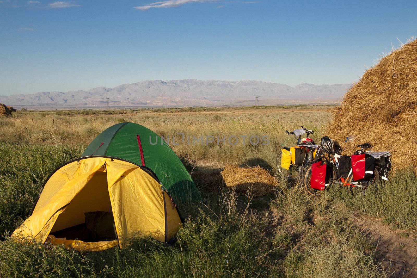 Two tents and two bicycles on the green grass - Turkey. Summer day