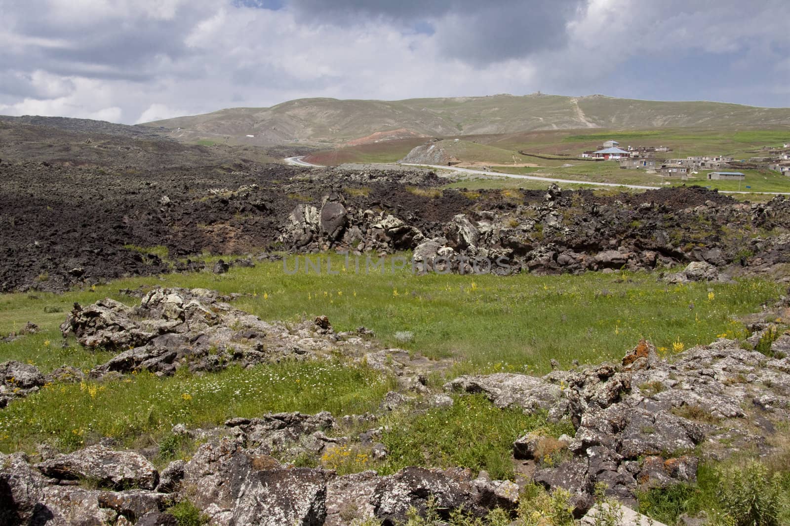 Vulcanic rocks in Turkey near Dogubayazit. In background small village and big mountain
