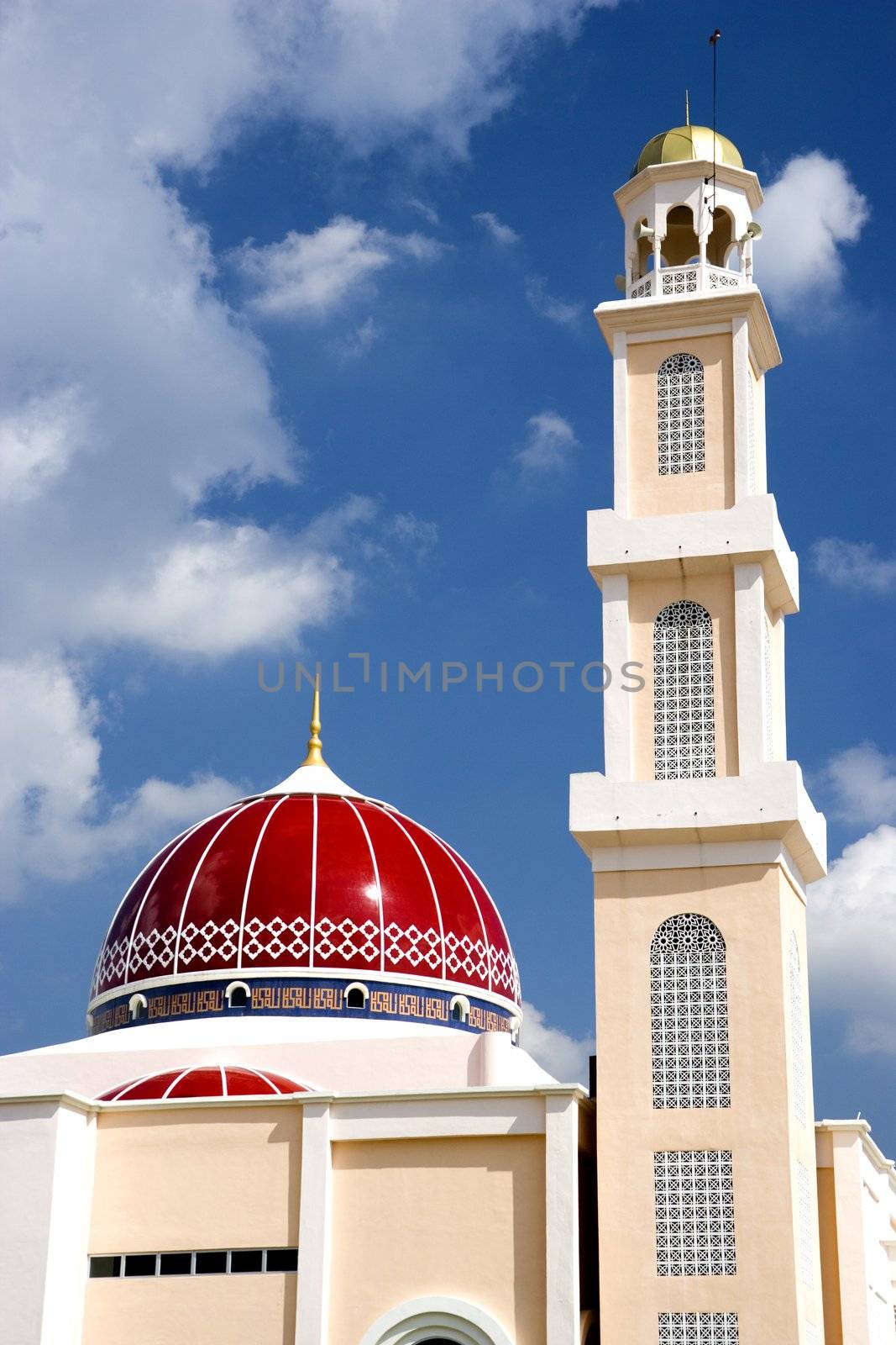 A modern red domed mosque in Malaysia.