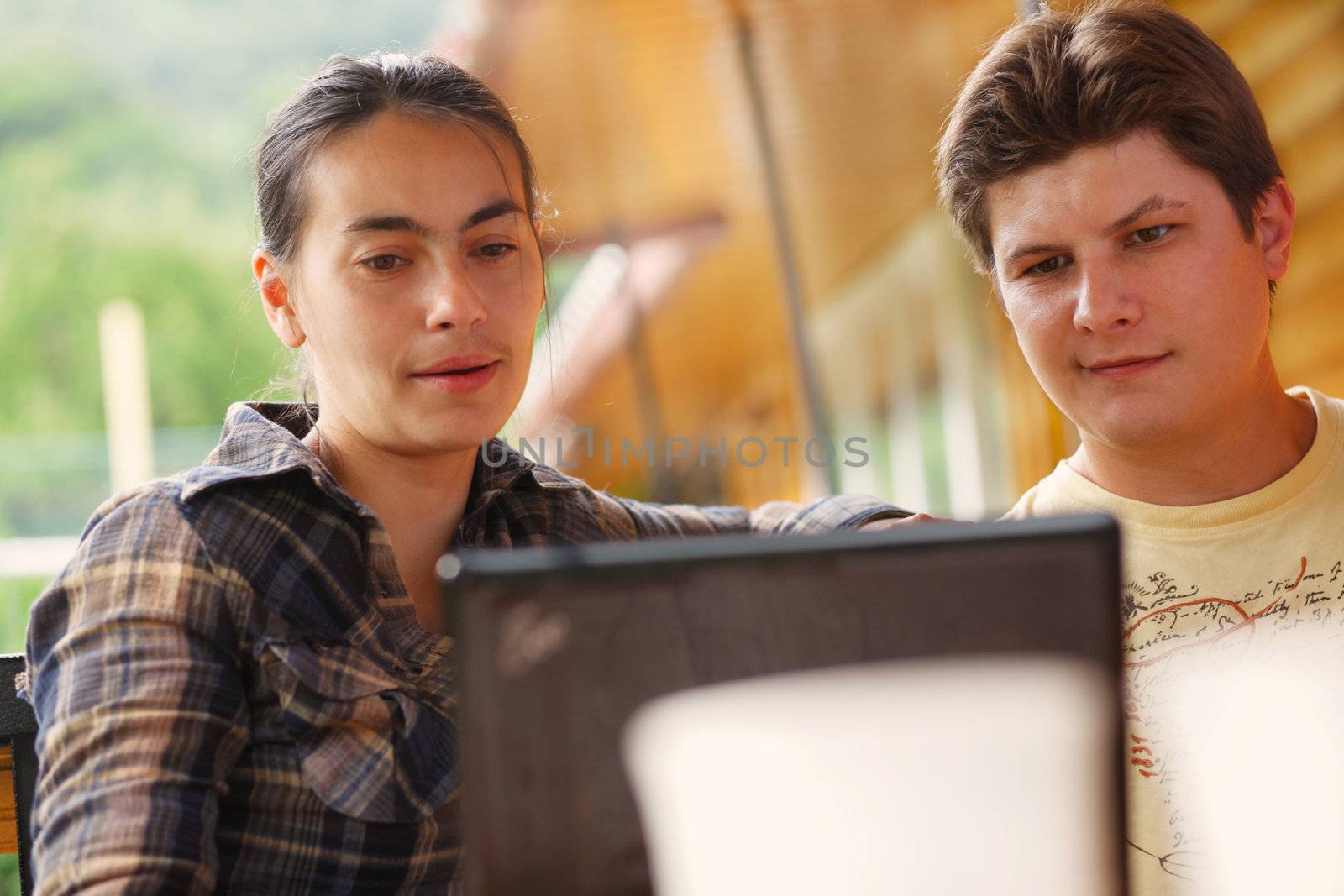 Close-up of man and woman  working on laptop.