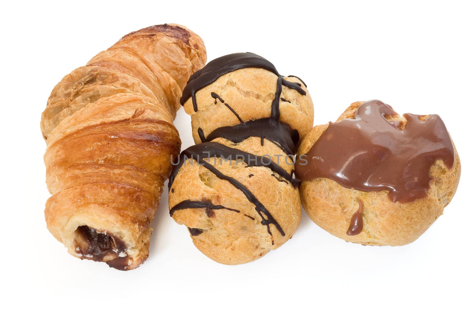 three chocolate and nut pastries isolated on white background