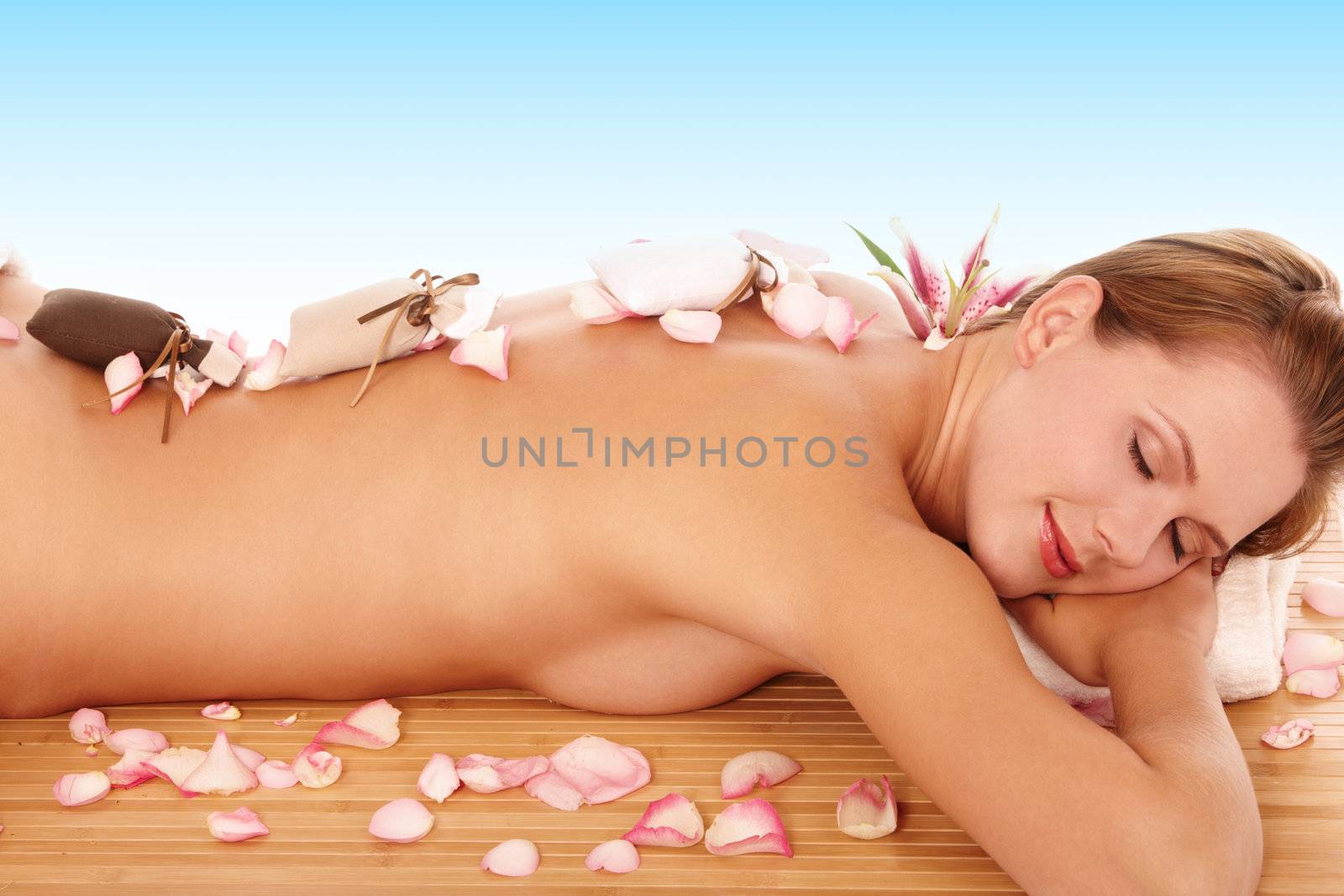 Young woman relaxing at spa with closed eyes