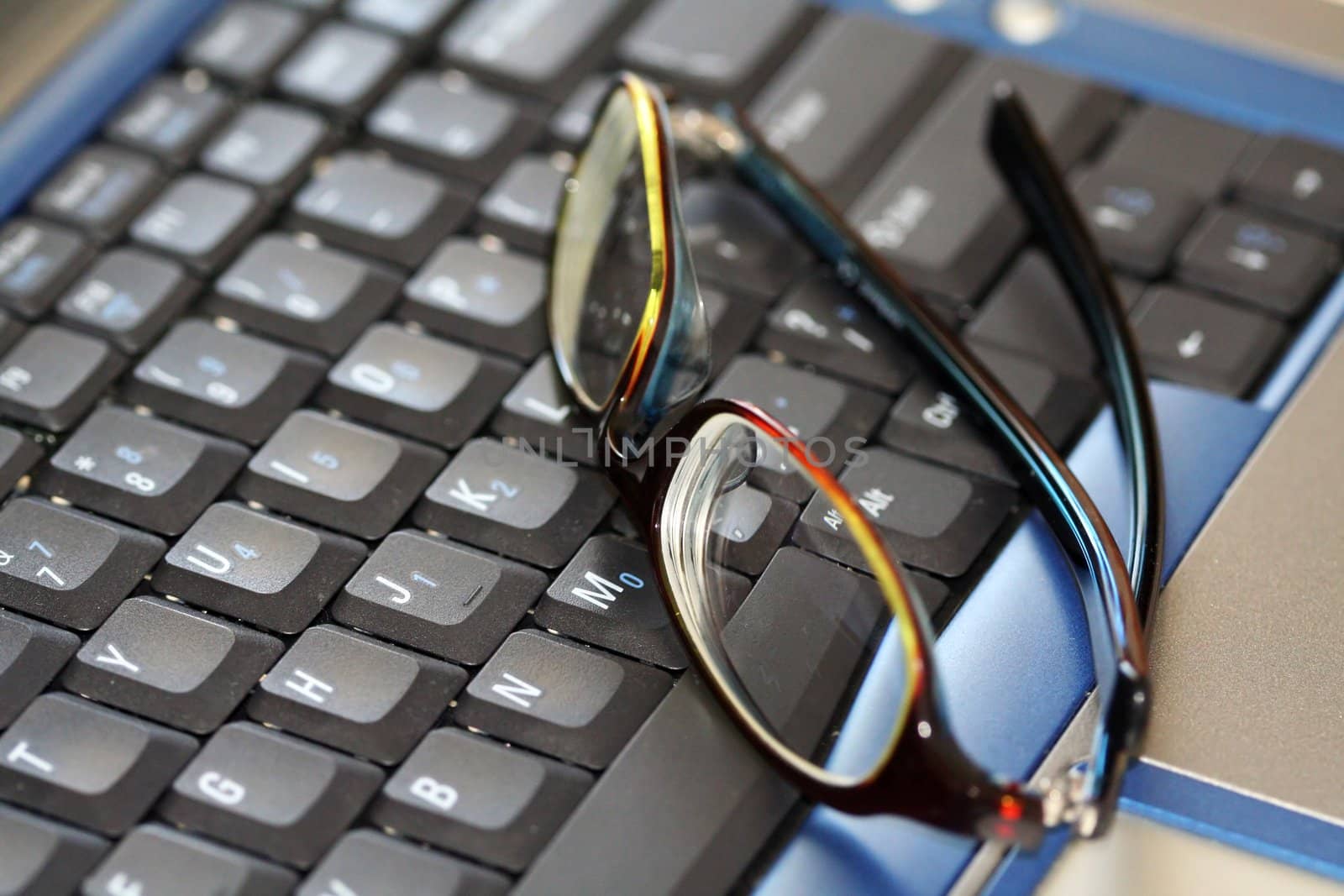 Glasses on a laptop by aremafoto