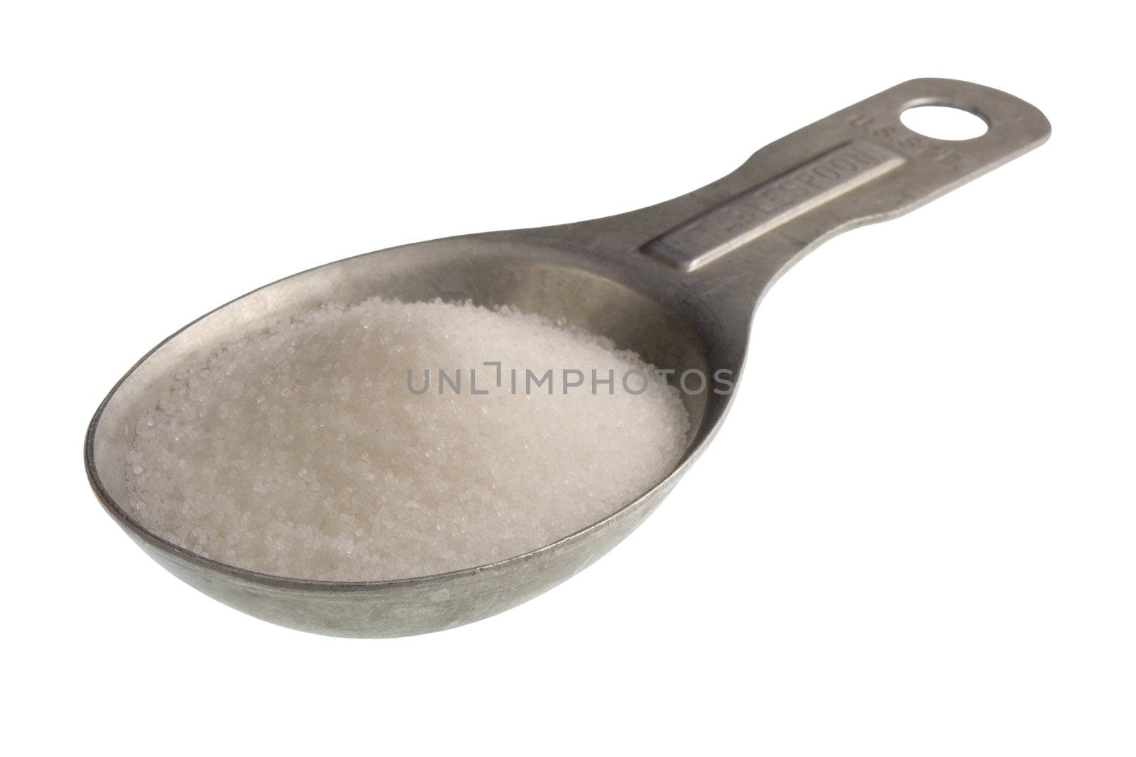 old aluminum measuring spoon full of salt isoalted on white, clipping path included