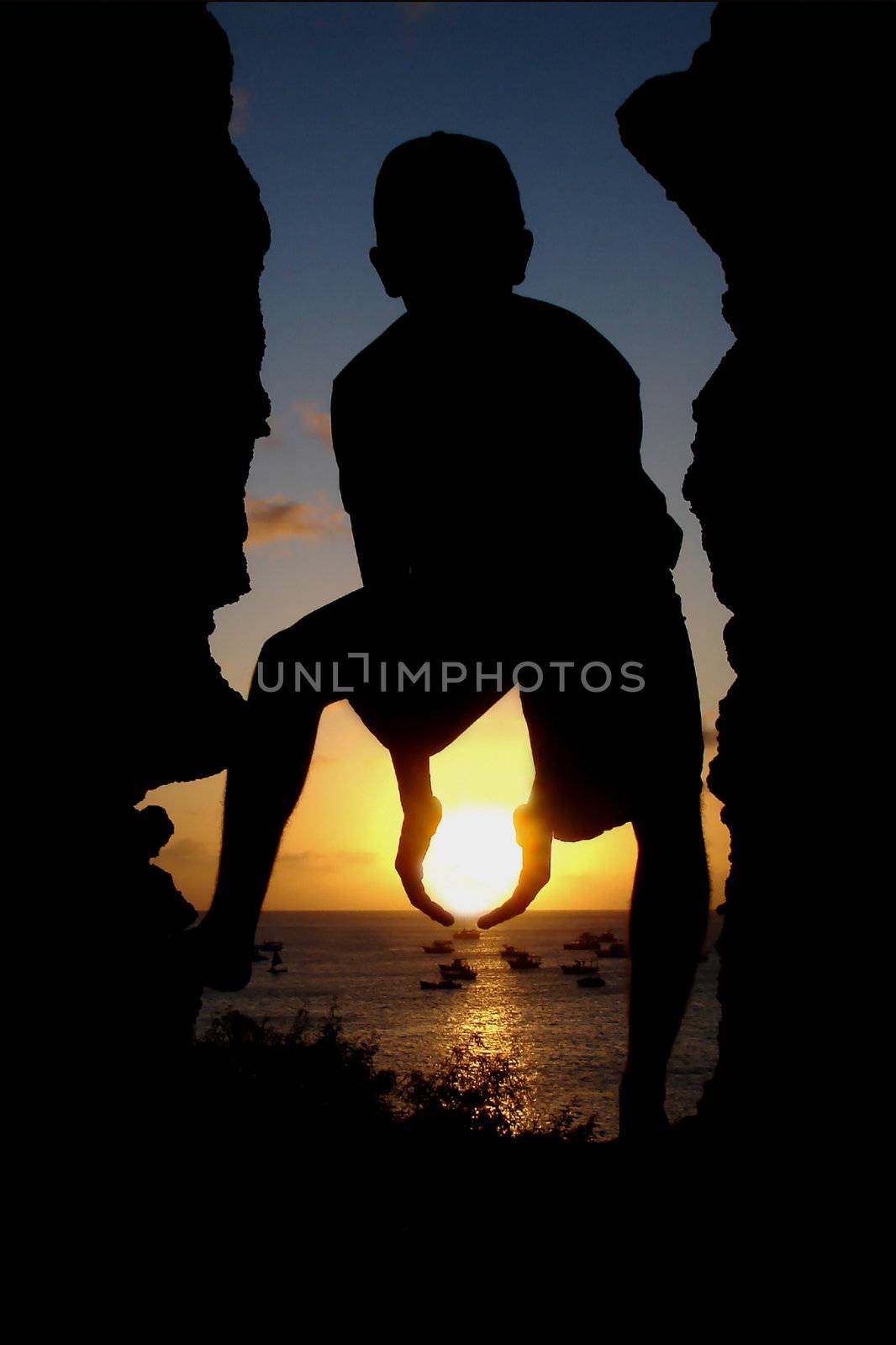 The silhouette of a young person holding the Sun.