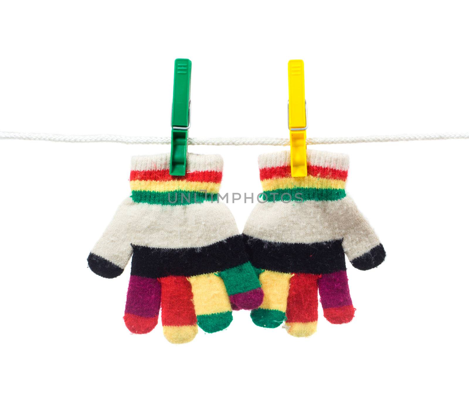 multi colour two kid gloves on clothes line isolated on white