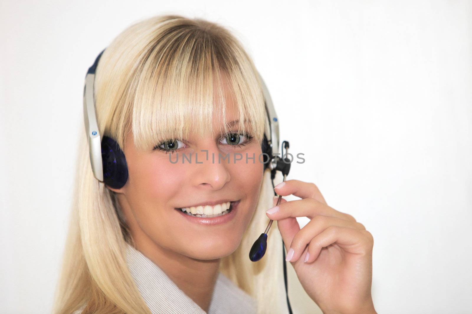 Portrait of a young smiling woman with a headset