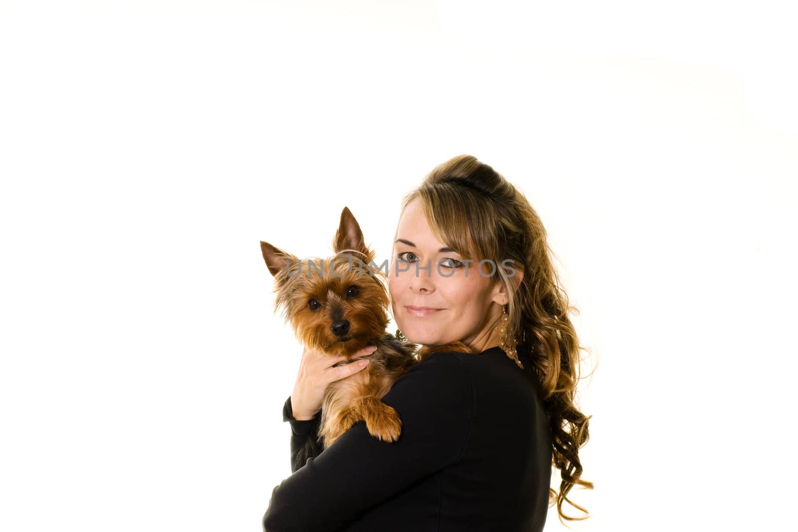 Studio portrait of attractive woman holding a yorkshire terrier dog