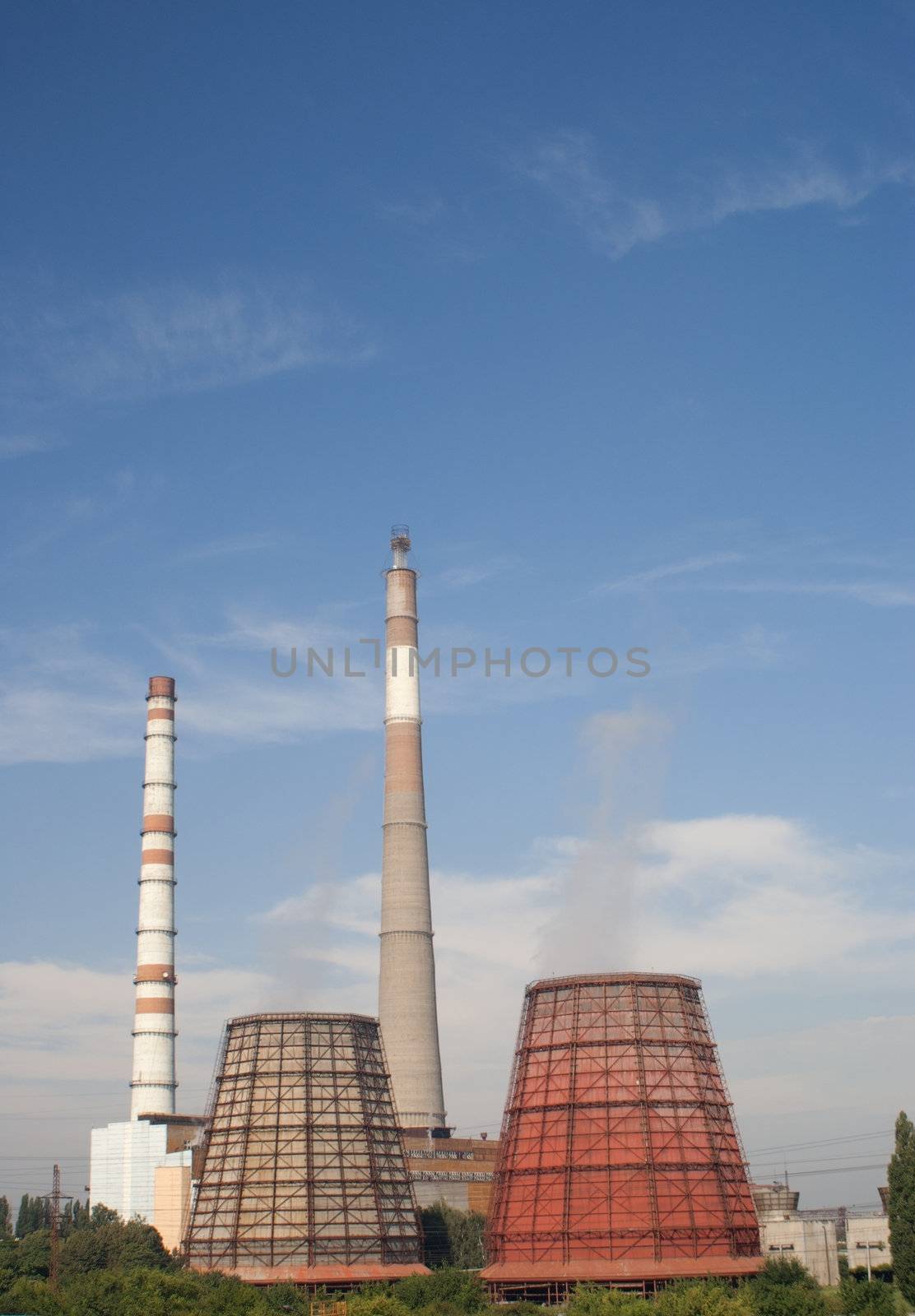 Refinery industrial pipes against blue sky by AndreyKr