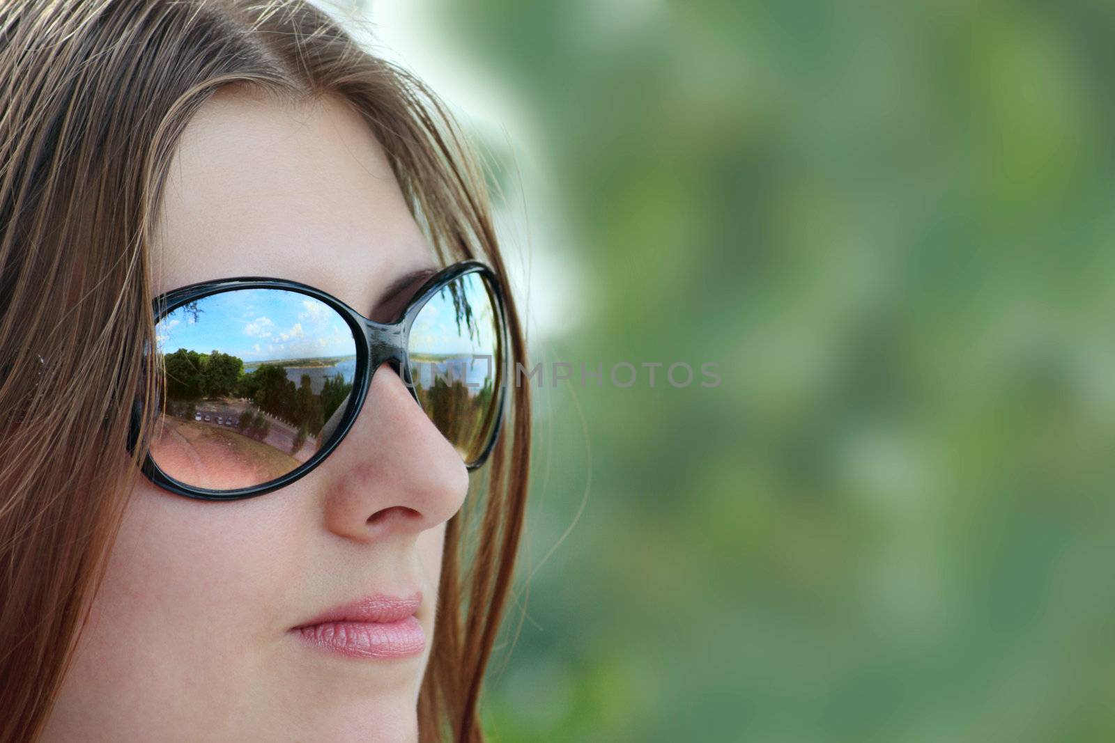 The nice girl in sun glasses removed close up