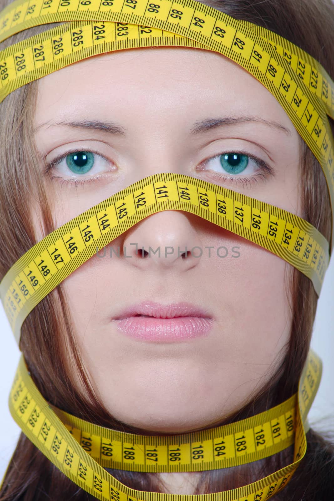 The girl with measuring metre wrapped up round a head