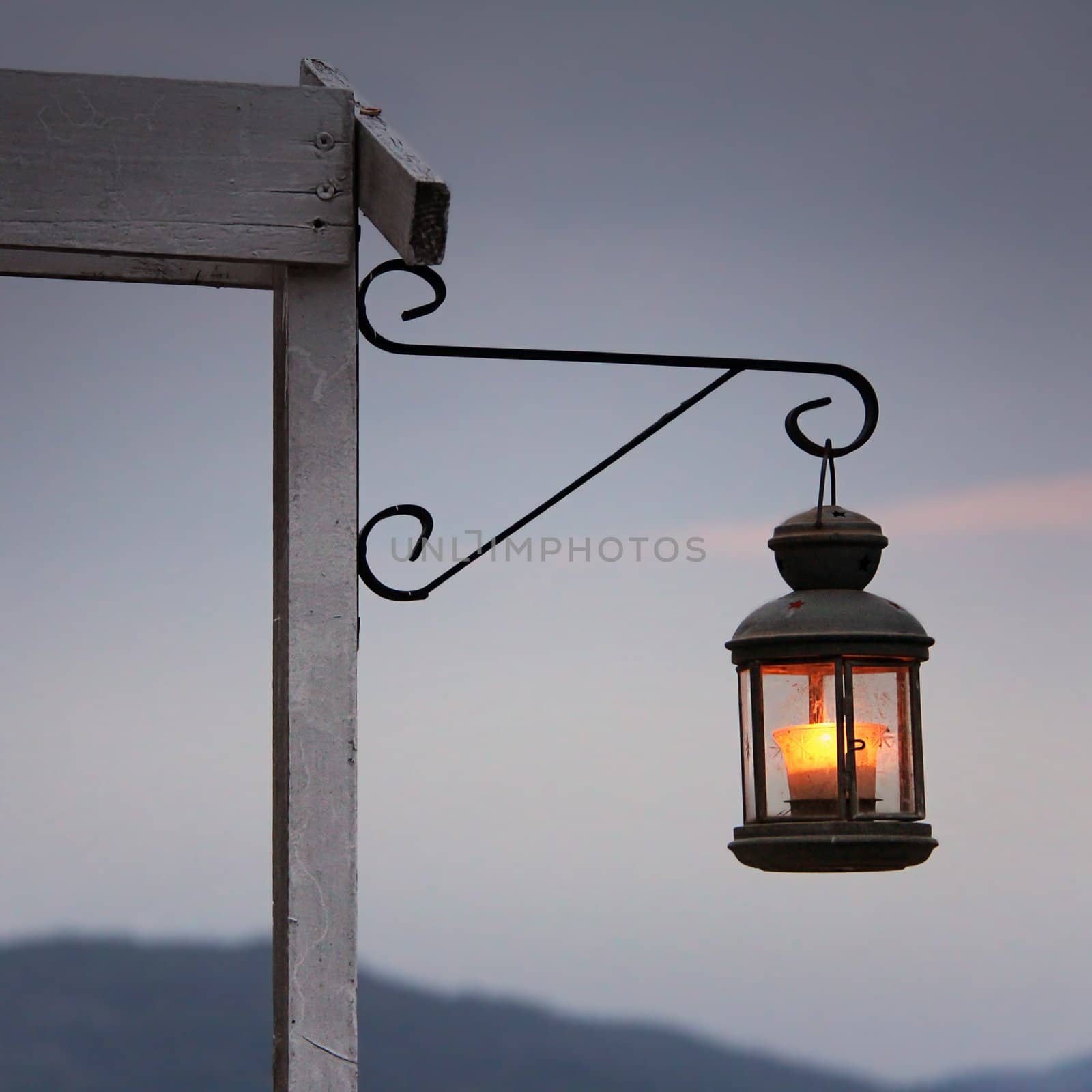 Old romantic lantern in front of the sunset
