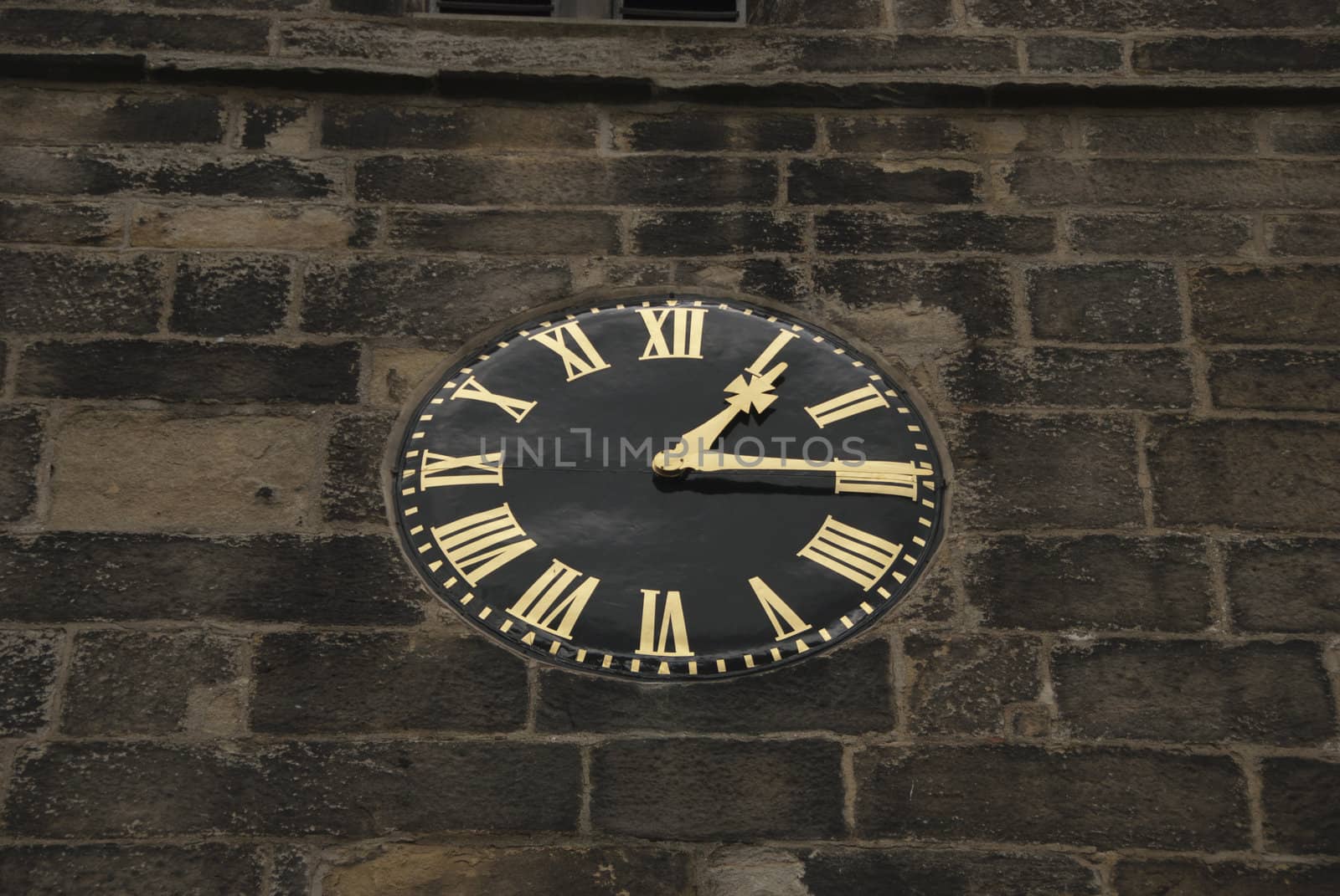 A Vintage Black and Gold Clock on a Church Tower