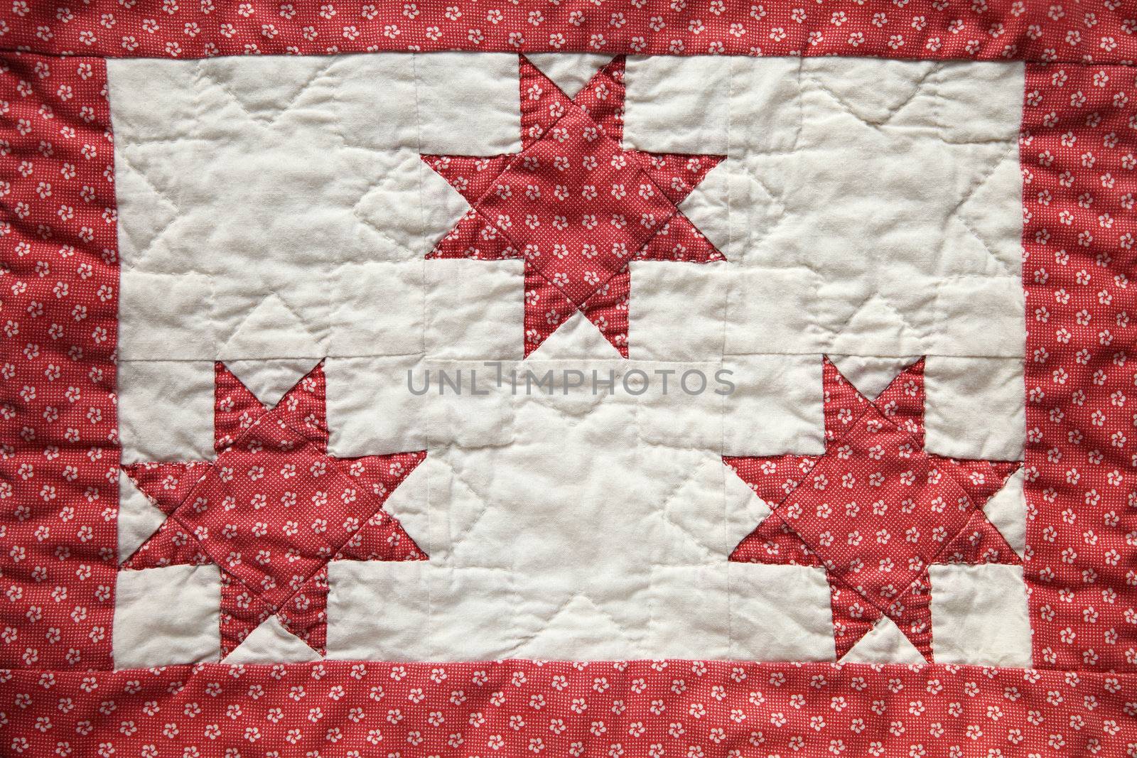 three eight-point quilted stars with a border