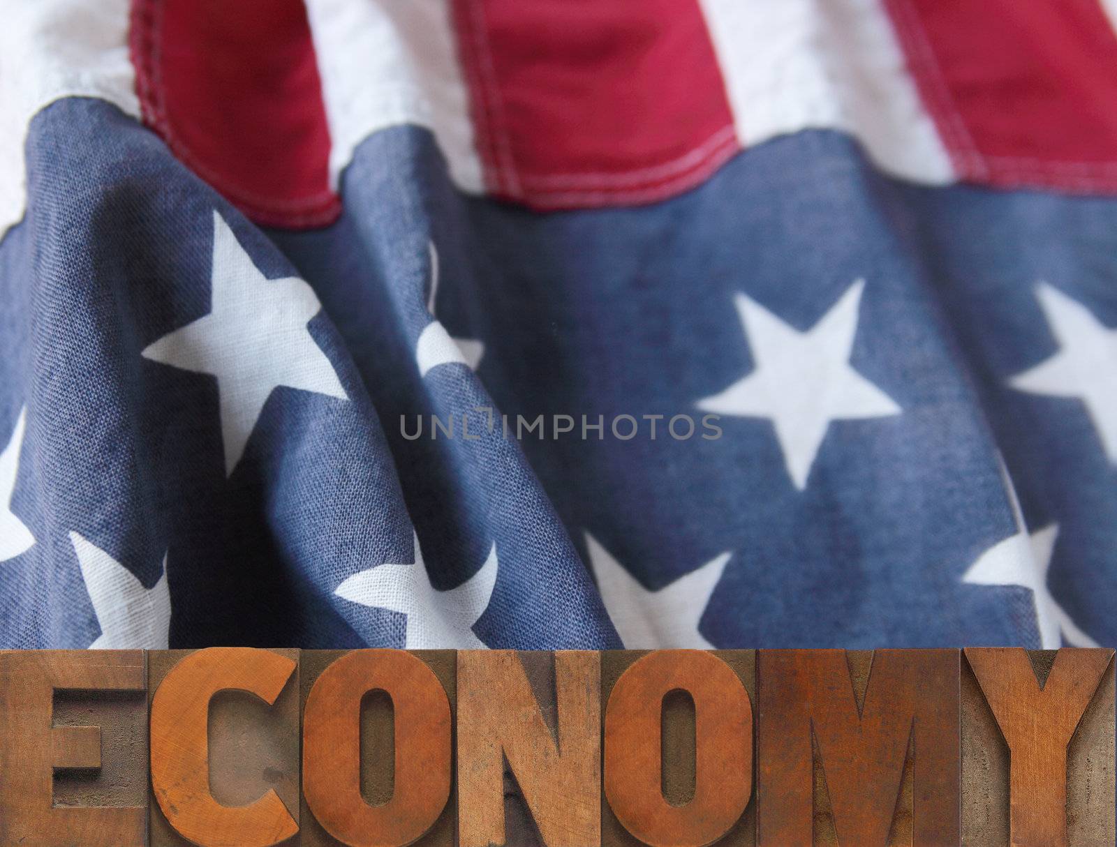 American flag with economy word in wood type