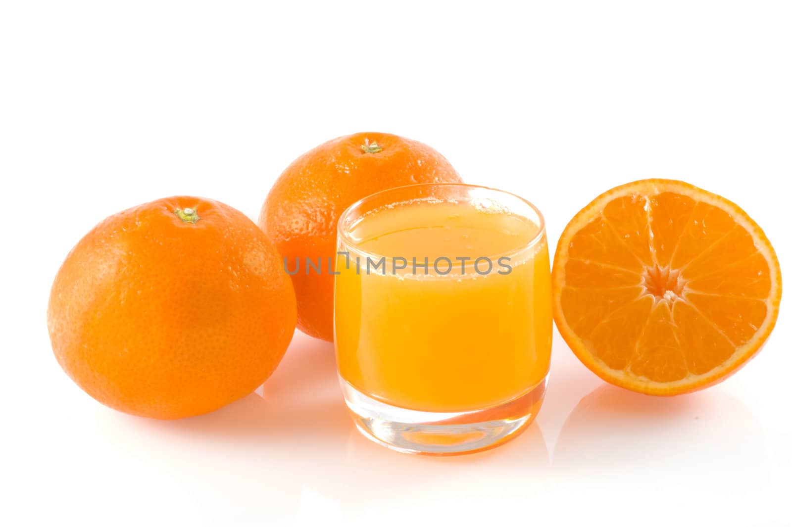 Two and half orange and a glass of fresh orange juice, isolated on white.