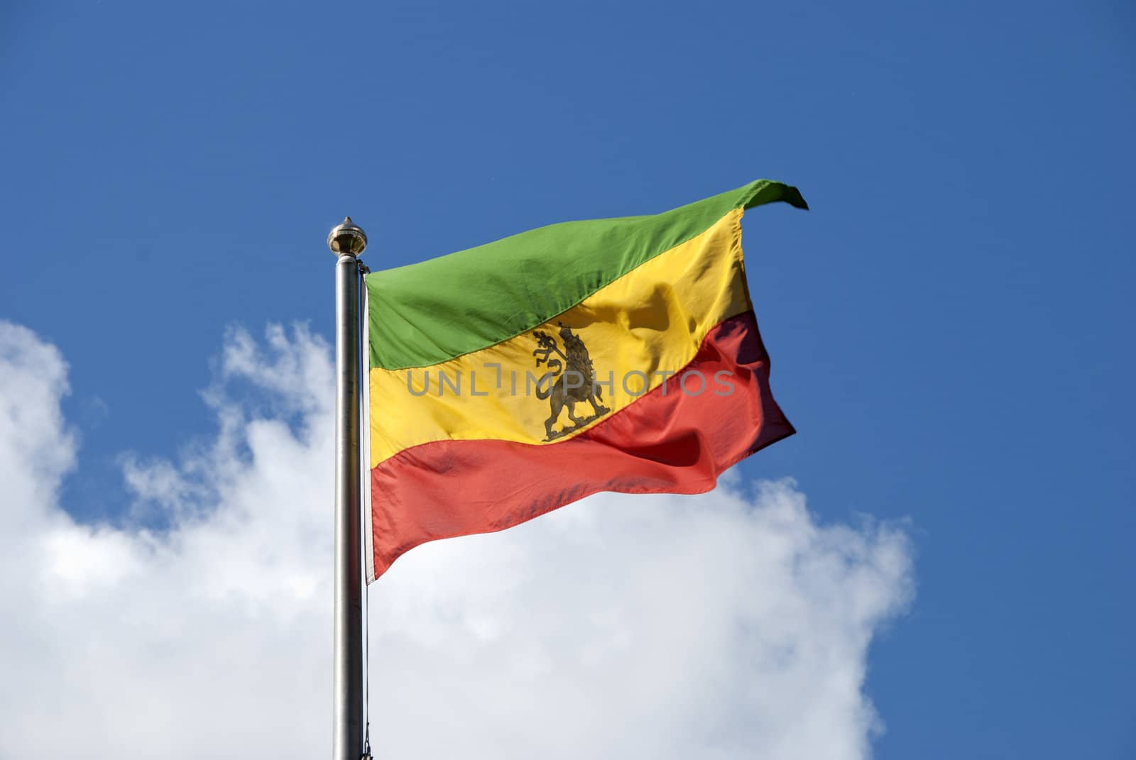 An Ethiopian Flag fluttering in the wind under a blue sky