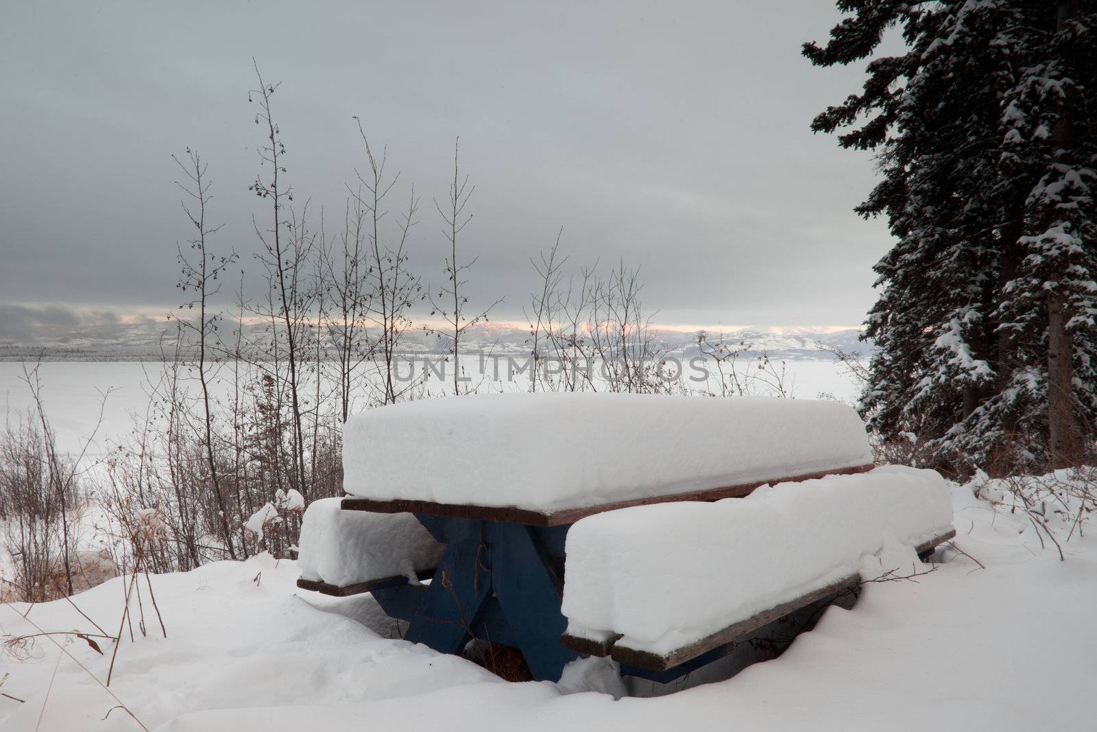 Closed for the season: beautiful lakeside campsite burried in snow.