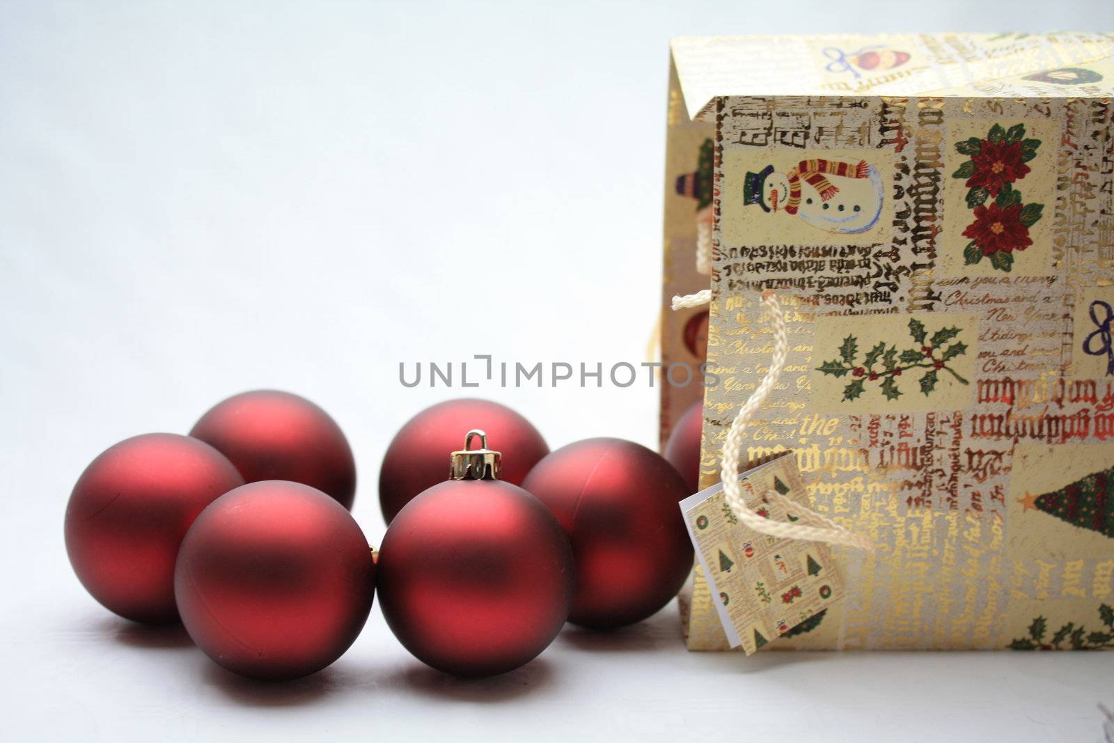 A christmas giftbag with red christmas balls