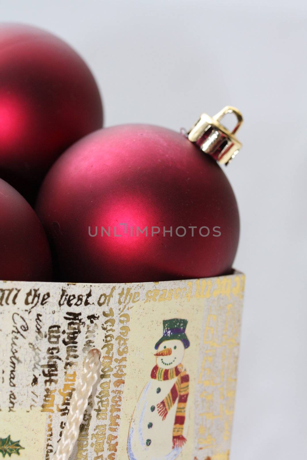 A christmas giftbag with red christmas balls