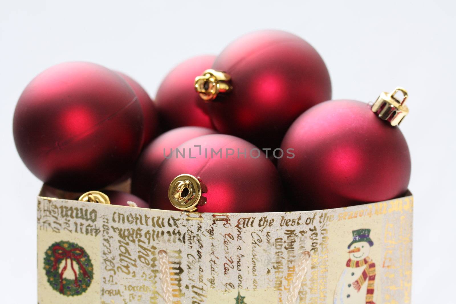 A christmas giftbag with red christmas balls