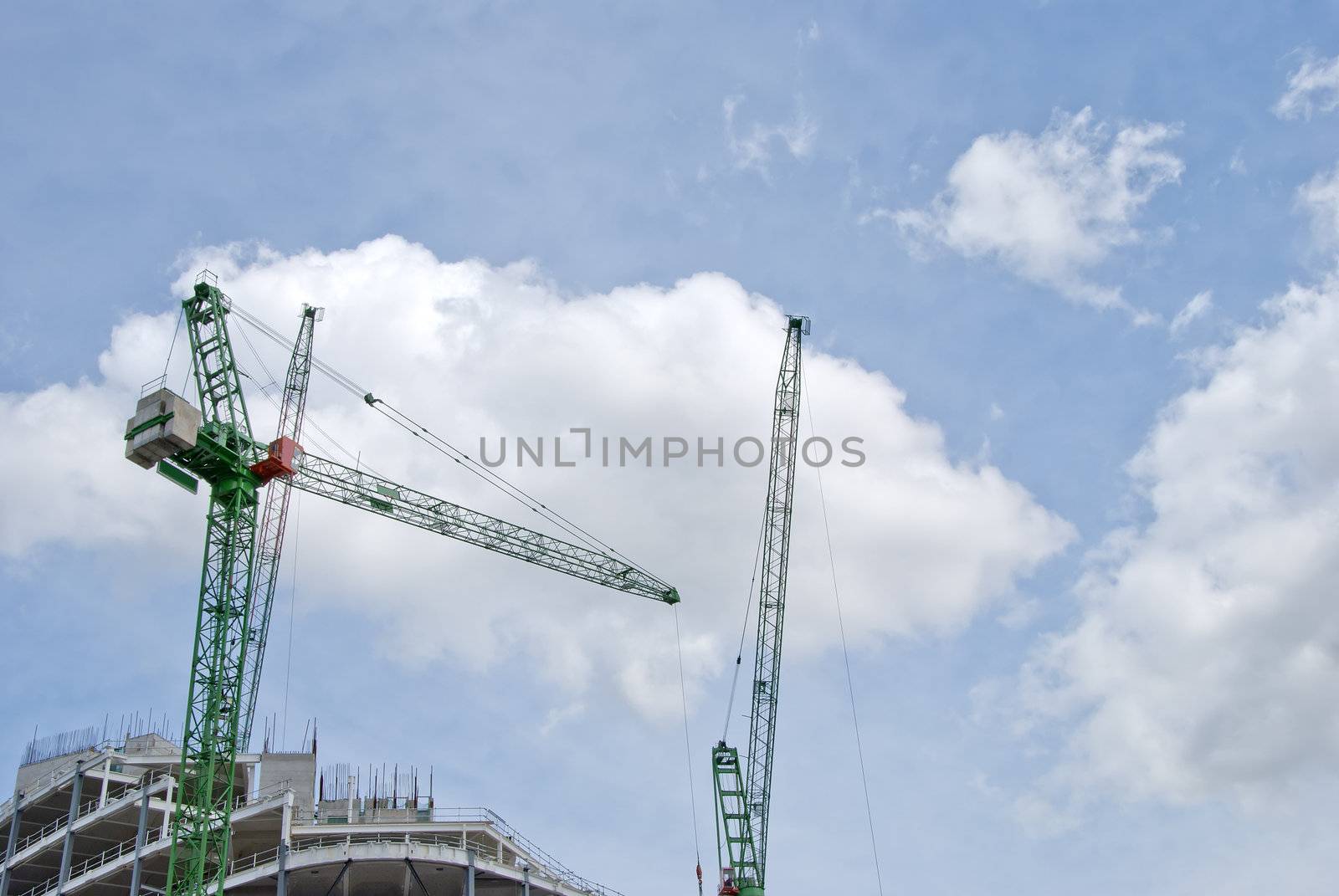 Two Green Heavy Lift Tower Cranes on a construction Site