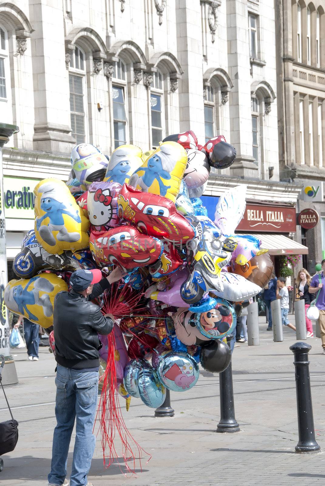 Man selling balloons on a shopping precinct