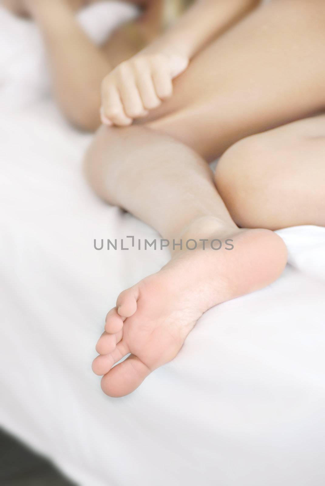 young sleeping girl foot closeup on bed