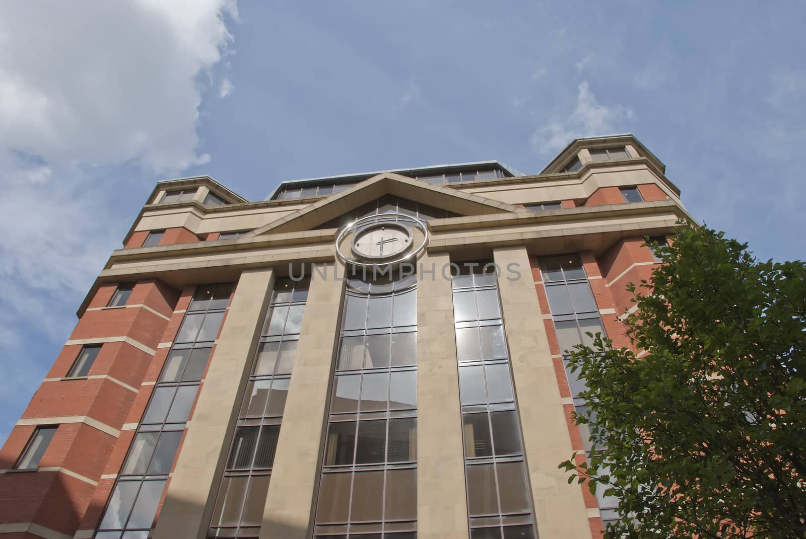 A Red Brick and Glass Office Block with Modern Clock