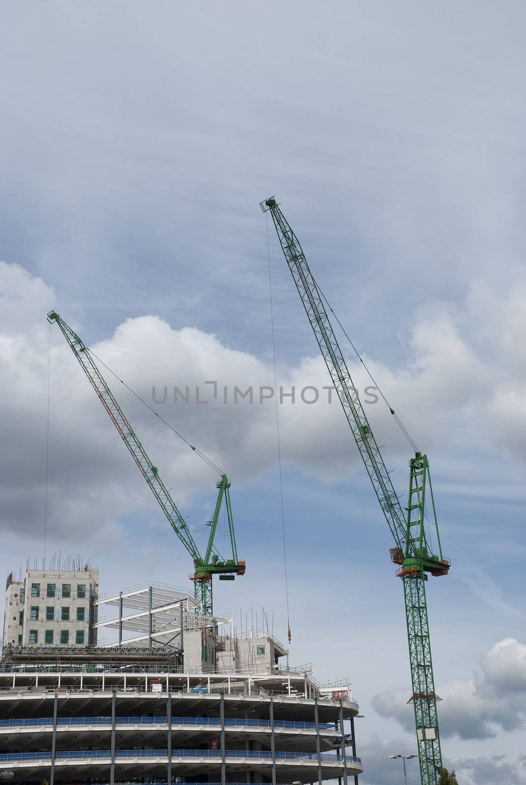 Two Green Tower Cranes a building under construction