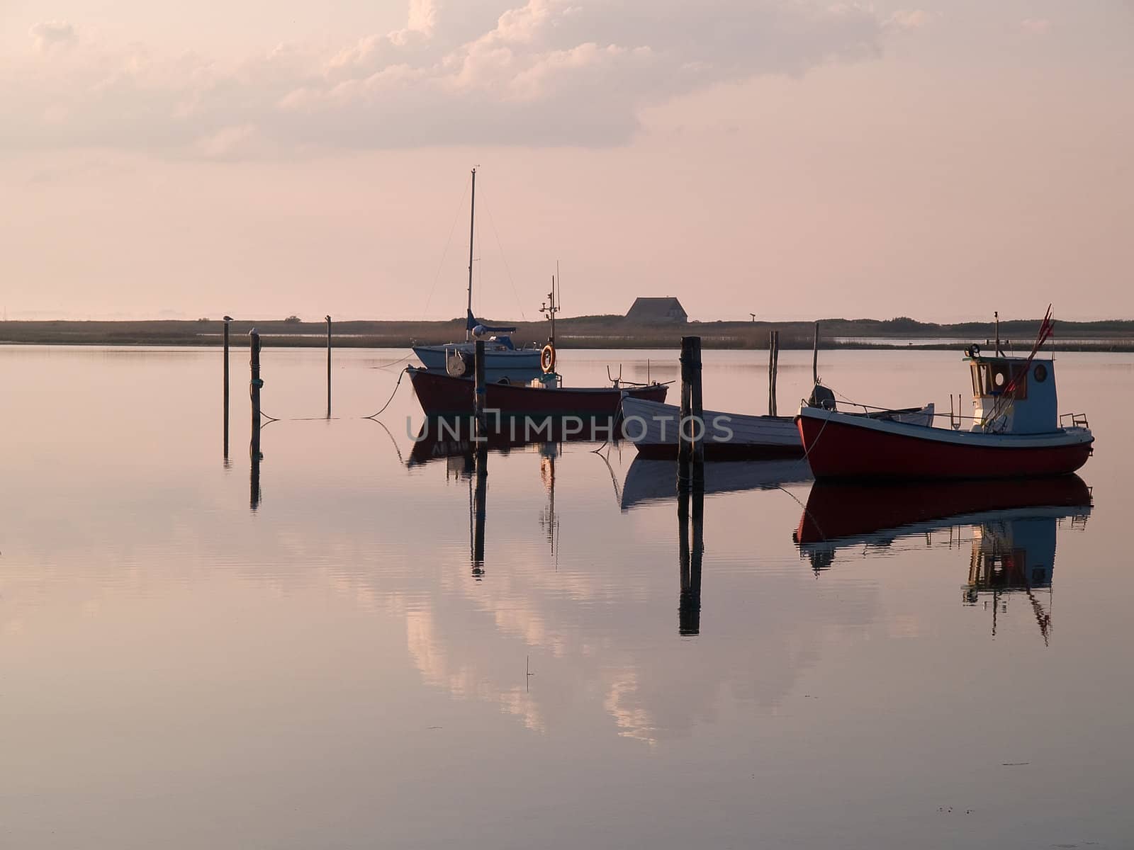 Magical reflection of a small dinghy dory boats in the sunset great sailing boating fishing image