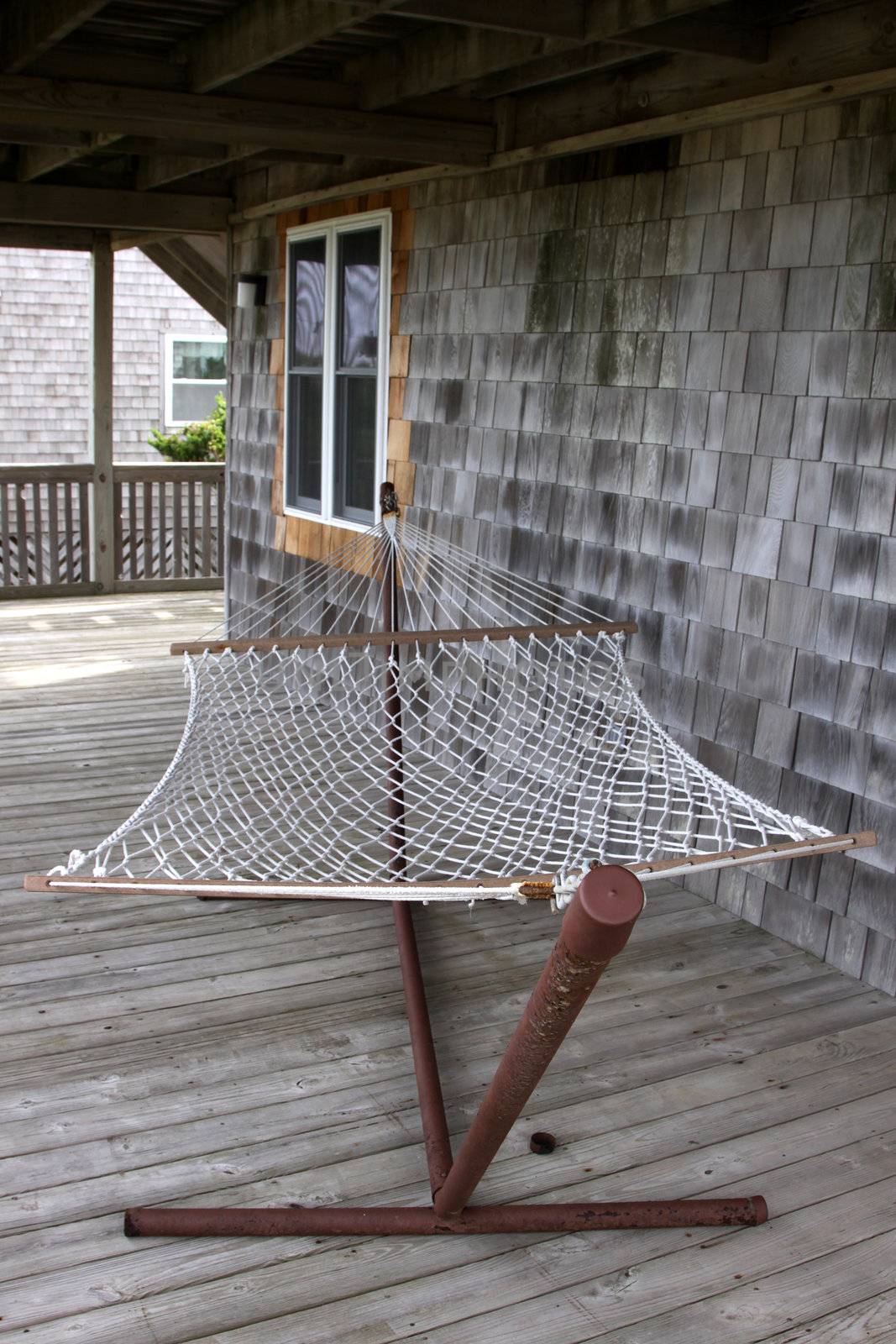 A hammock sitting on the deck of an Outer Banks beach house.
